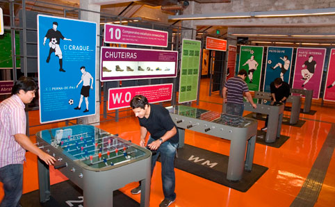 Guys play table football at the Museu do Futebol