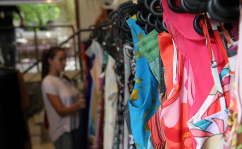 Clothes hanging on a rack at a second-hand store